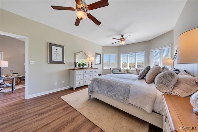 bedroom featuring baseboards, ceiling fan, and wood finished floors