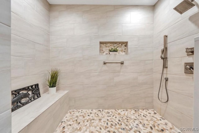 bathroom with tiled shower