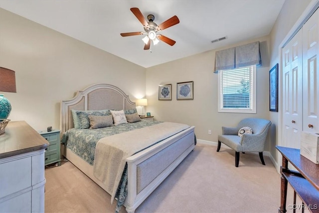 bedroom featuring light colored carpet, baseboards, ceiling fan, and visible vents