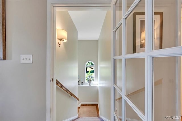 staircase featuring baseboards