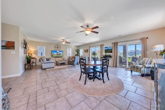 dining area featuring ceiling fan and baseboards
