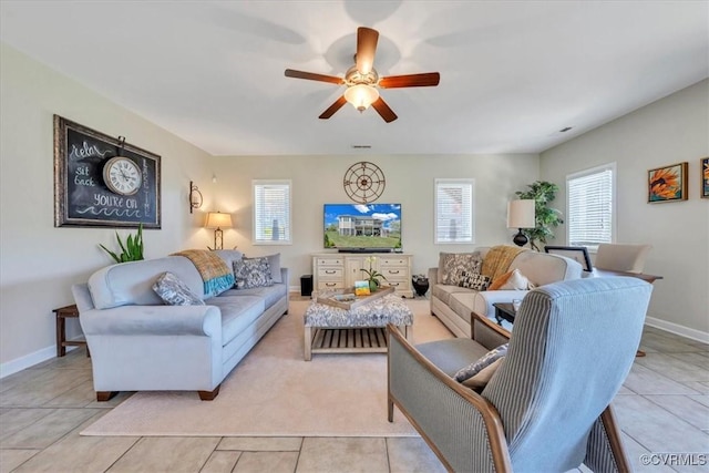 living area featuring a ceiling fan, plenty of natural light, and light tile patterned floors