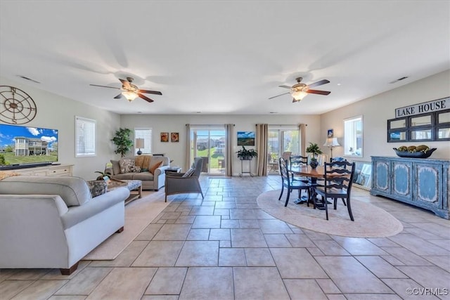 living area featuring ceiling fan and visible vents