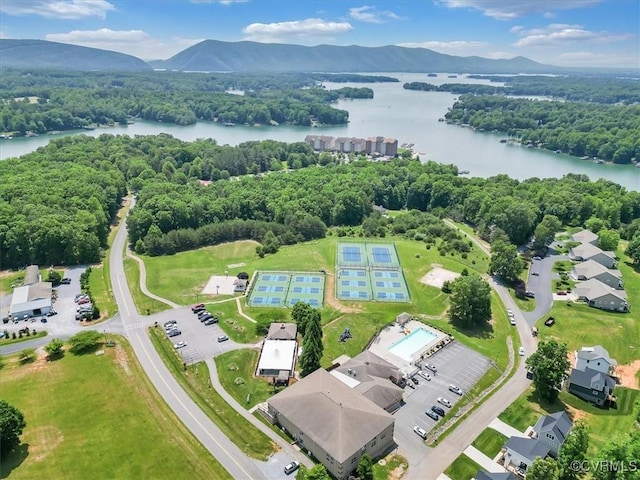 drone / aerial view featuring a forest view and a water and mountain view