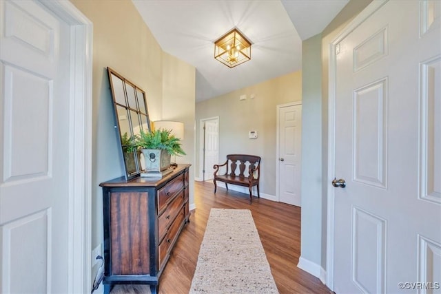 hallway with baseboards and wood finished floors