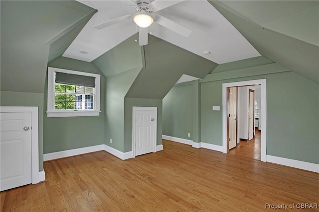 bonus room with vaulted ceiling, baseboards, a ceiling fan, and wood finished floors