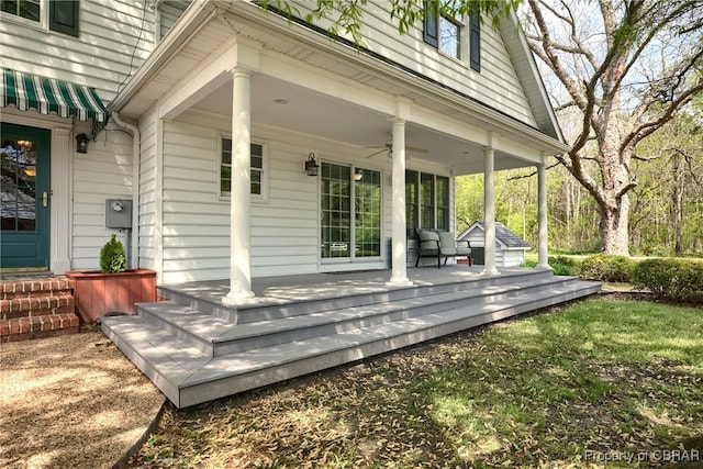 wooden deck with a porch and ceiling fan