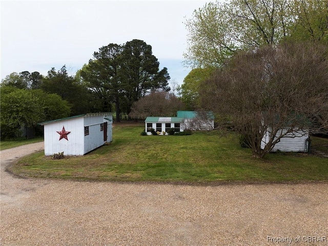 exterior space featuring an outbuilding, a shed, and dirt driveway