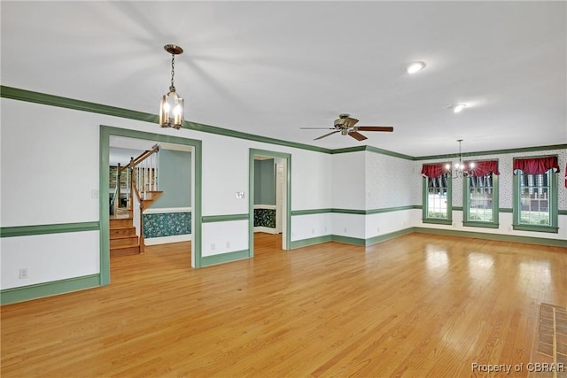 unfurnished room with light wood-style flooring, visible vents, and crown molding