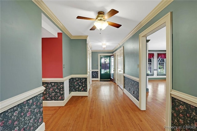 entryway with ceiling fan, baseboards, wood finished floors, and ornamental molding