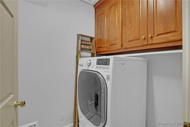 laundry area featuring cabinet space and washer / clothes dryer