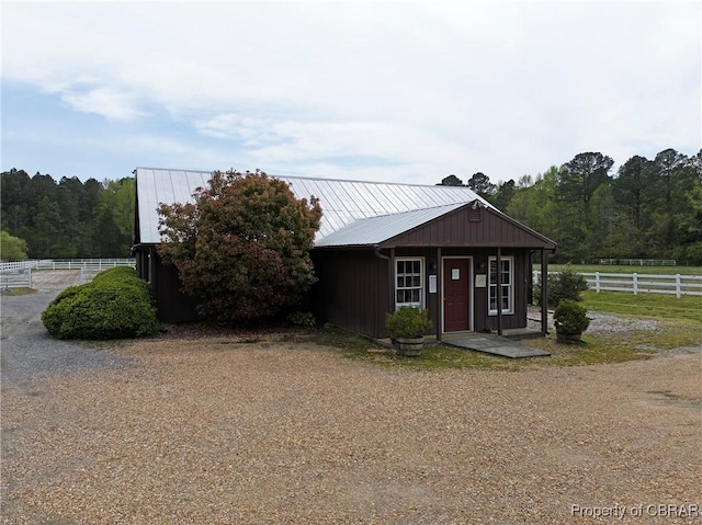 view of front facade with metal roof and fence
