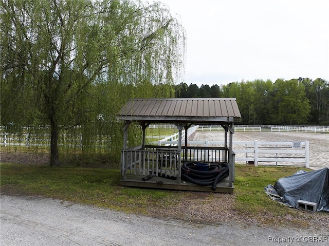 exterior space with fence and a view of trees