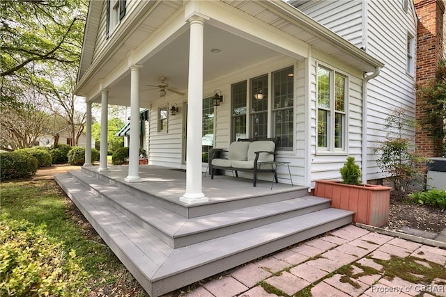 deck with a ceiling fan and covered porch