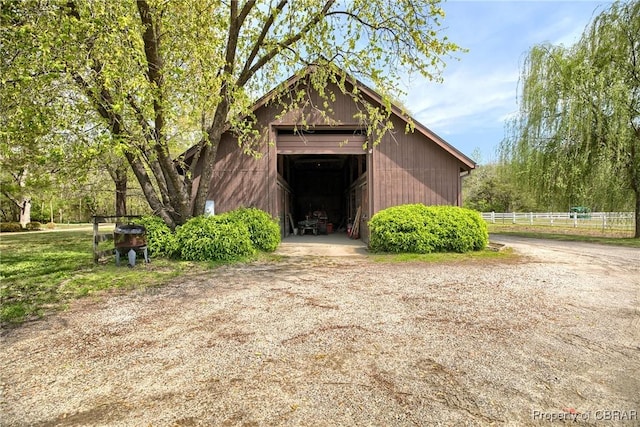 exterior space with fence and an outbuilding
