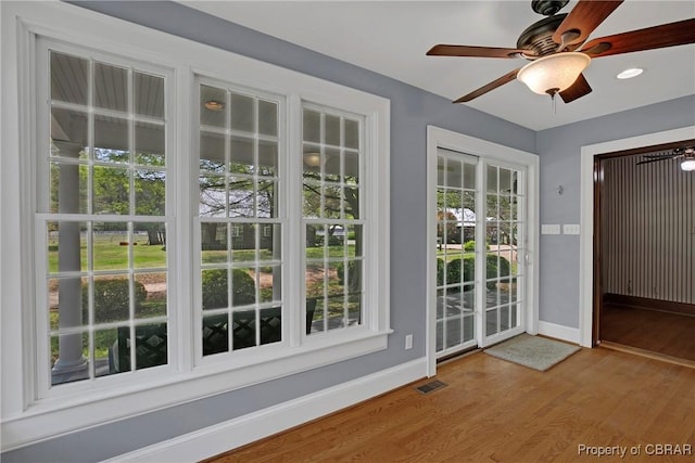 doorway featuring baseboards, visible vents, recessed lighting, wood finished floors, and ceiling fan