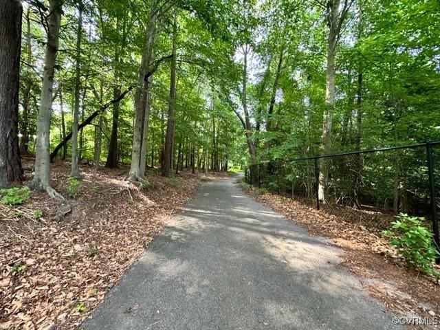 view of road featuring a wooded view