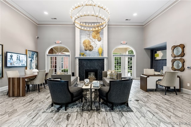 interior space with visible vents, an inviting chandelier, baseboards, a high ceiling, and a high end fireplace