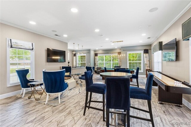 dining room featuring baseboards, ornamental molding, and recessed lighting