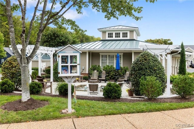 view of front of property featuring a porch, metal roof, and a standing seam roof