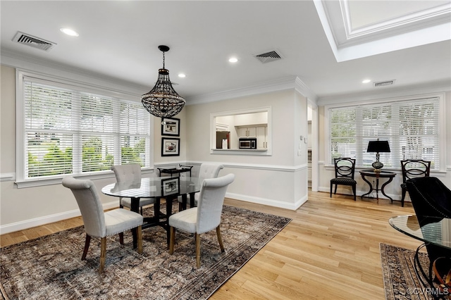 dining area with visible vents and crown molding