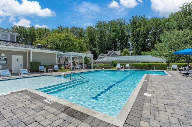 pool featuring a patio and a pergola