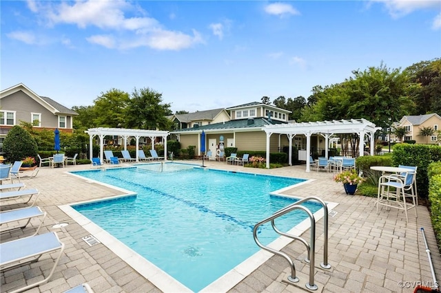 community pool with a pergola and a patio area