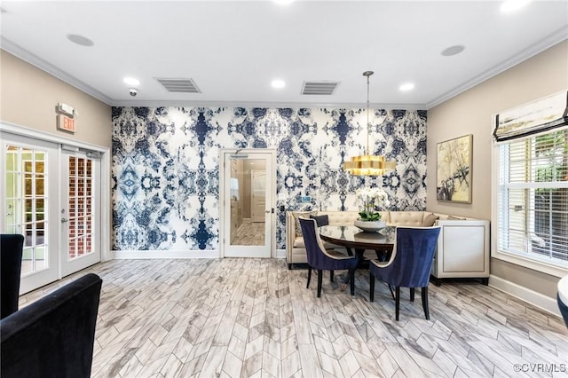 dining room featuring crown molding, baseboards, visible vents, and wallpapered walls