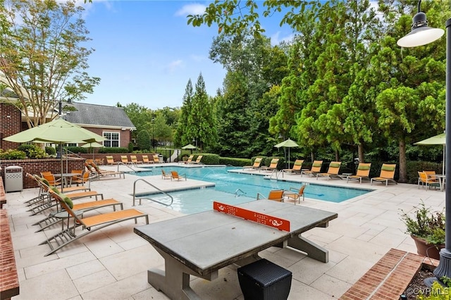pool featuring a patio area and fence