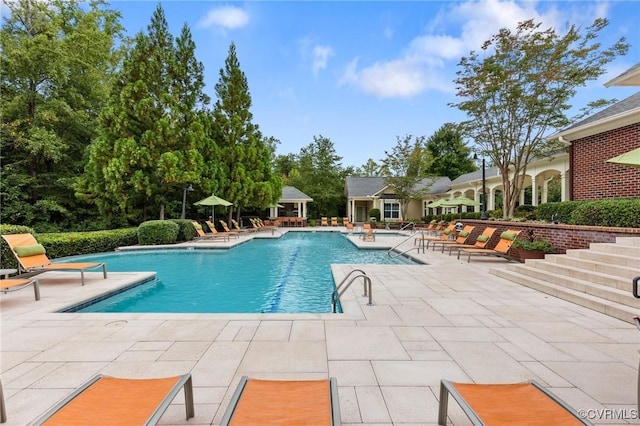 community pool with a patio area