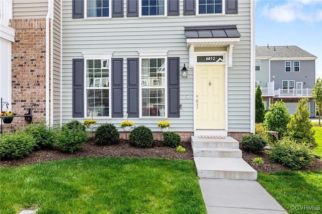 6812 Leire Ln, Chesterfield, VA 23832 - view of exterior entry featuring a yard and a standing seam roof