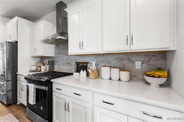 6812 Leire Ln, Chesterfield, VA 23832 - kitchen featuring freestanding refrigerator, wall chimney exhaust hood, range with gas cooktop, white cabinets, and light countertops