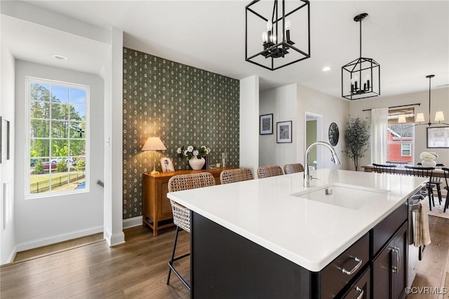 6812 Leire Ln, Chesterfield, VA 23832 - kitchen featuring a sink, an accent wall, a chandelier, wallpapered walls, and baseboards