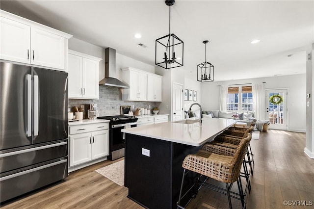 6812 Leire Ln, Chesterfield, VA 23832 - kitchen with freestanding refrigerator, wall chimney range hood, electric range oven, a sink, and open floor plan