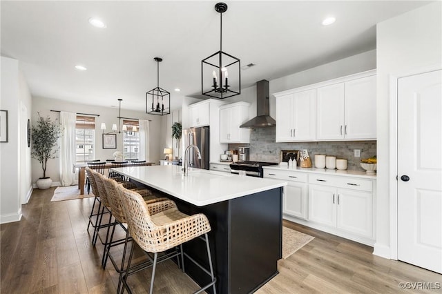 6812 Leire Ln, Chesterfield, VA 23832 - kitchen with wall chimney range hood, an island with sink, stainless steel appliances, recessed lighting, and backsplash
