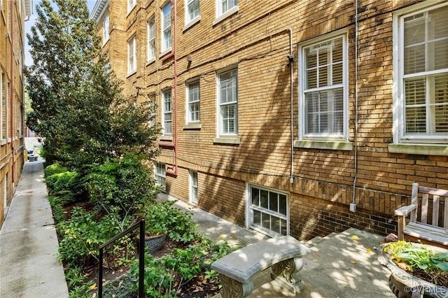 view of side of property featuring brick siding