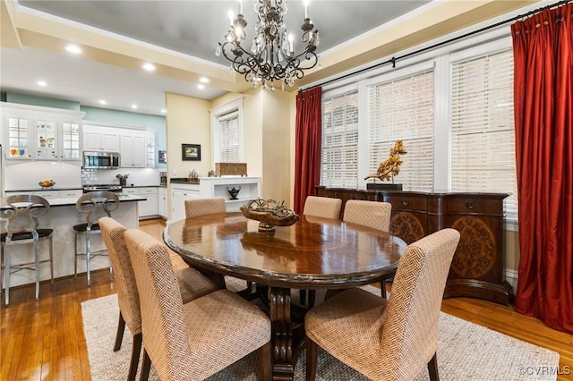 dining area with recessed lighting, a chandelier, and light wood finished floors