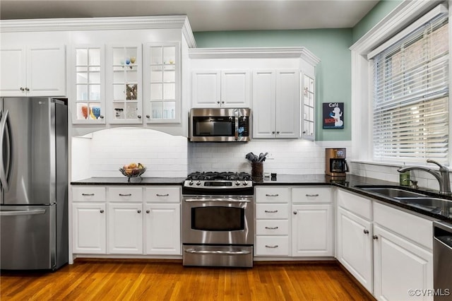 kitchen with a sink, white cabinetry, and appliances with stainless steel finishes