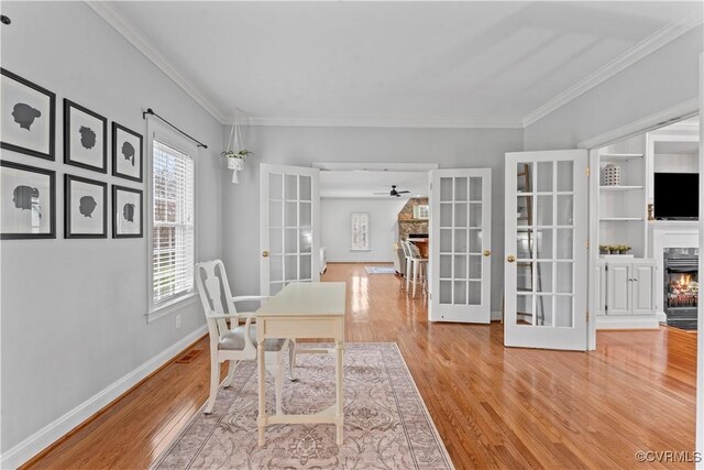 8500 Baldwin Creek Rd, Chesterfield, VA 23832 - dining room with crown molding, french doors, a warm lit fireplace, and wood finished floors
