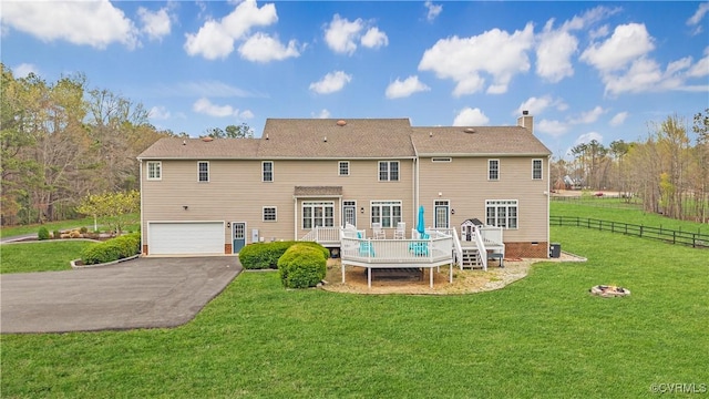 8500 Baldwin Creek Rd, Chesterfield, VA 23832 - back of property featuring a garage, aphalt driveway, a wooden deck, fence, and a chimney