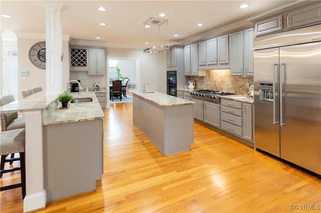 4900 Wellington Farms Dr, Chester, VA 23831 - kitchen with appliances with stainless steel finishes, gray cabinetry, a peninsula, crown molding, and light wood-style floors