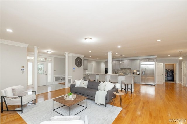 4900 Wellington Farms Dr, Chester, VA 23831 - living area featuring crown molding, ornate columns, light wood-type flooring, washer / dryer, and wainscoting