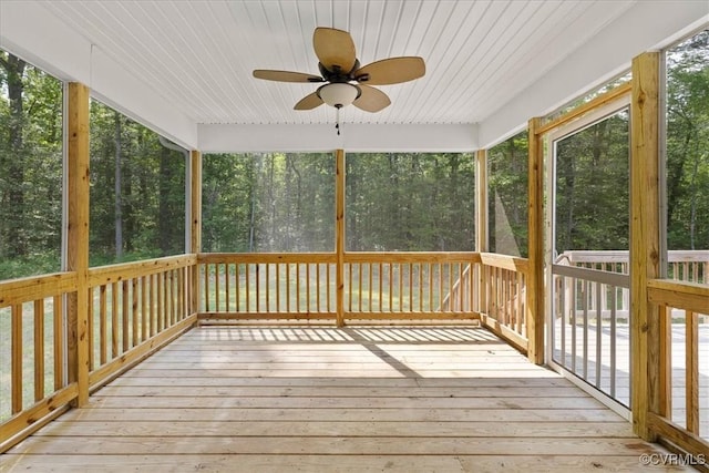 unfurnished sunroom with a ceiling fan