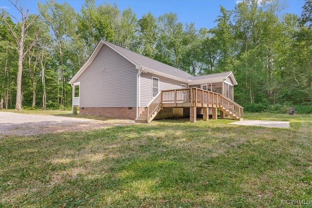 view of property exterior featuring a sunroom, a deck, stairway, crawl space, and a lawn