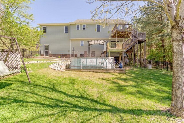 6360 Haleford Dr, Powhatan, VA 23139 - rear view of house with a lawn, a wooden deck, a fenced backyard, and stairs