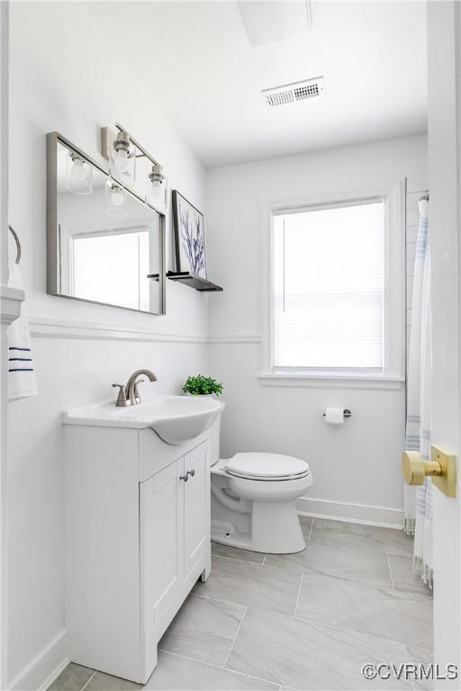 bathroom with visible vents, toilet, and vanity