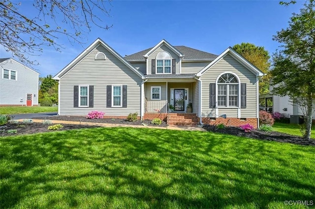 traditional home featuring roof with shingles, covered porch, and a front yard