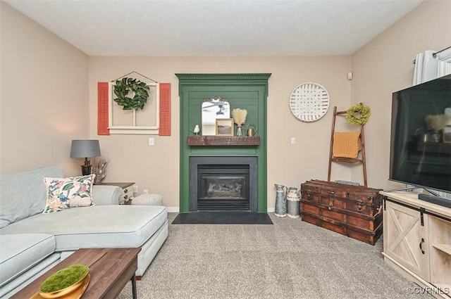 living area featuring baseboards, a fireplace with flush hearth, and carpet