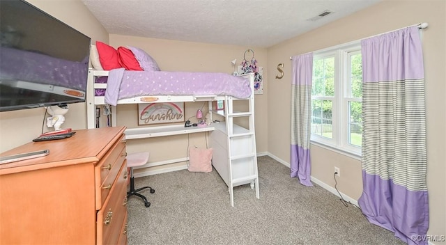 bedroom featuring visible vents, a textured ceiling, baseboards, and carpet floors
