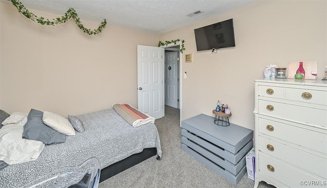 bedroom with visible vents and carpet